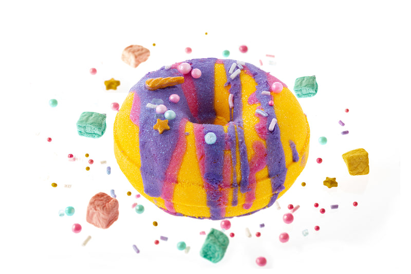 Unicorn Glitter donut bath bomb is a beautiful yellow with sprinkles and cosmetic glitter glazed with a deep purple and deep fuchsia color surrounded with sprinkles and unicorn poop marshmallows