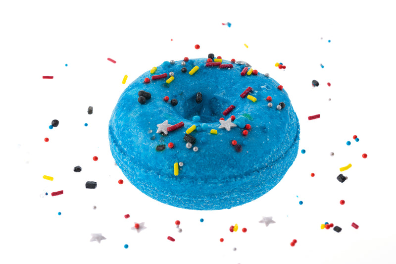 Scented galaxy donut bath bomb is a deep blue with silver stars and red, yellow, and blue sprinkles GREAT for kids bath soaks