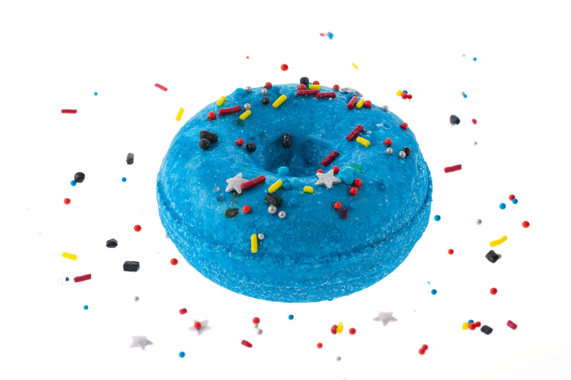Galaxy donut bath bomb. A deep blue with silver stars and red, yellow, and blue sprinkles.