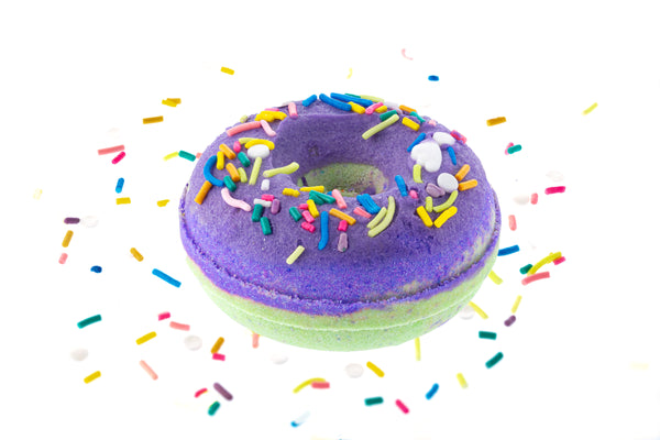 Juicy Pear Donut Bath Bomb A lime green donut with purple glaze and multi-colored sprinkles.